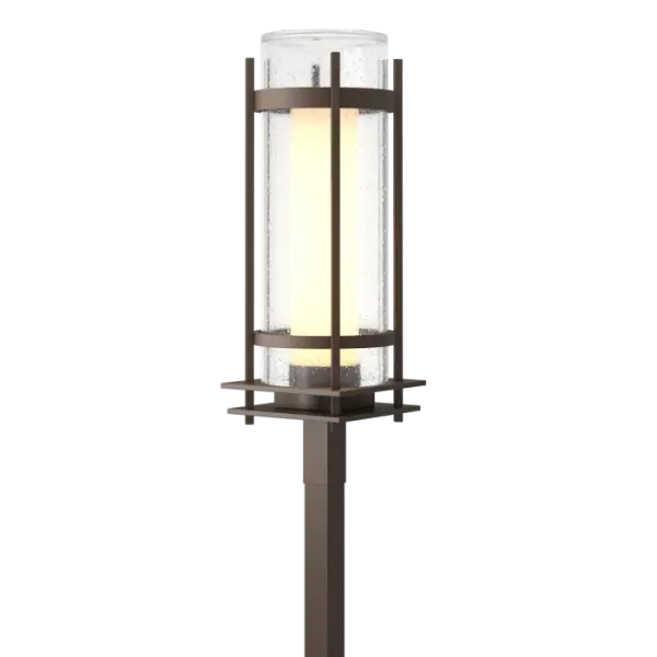 A contemporary look updates a Hubbardton Forge classic. Double-glass cylinders, with a frosted inner and clear seeded outer glass, light the path for guests. Adding both beauty and security to any property, the Torch Outdoor Post Light is appropriate for a wide variety of architectural designs.