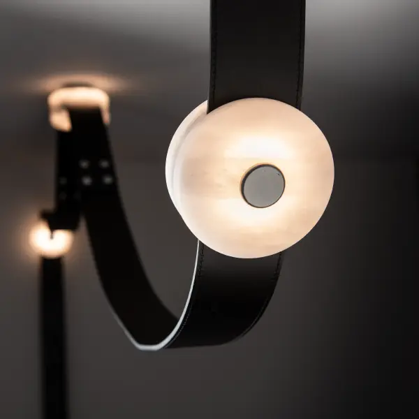 The SNAPS Small LED Pendant designed by HF's Andy Morter features a single alabaster stone-LED element on a long strap, with an additional, shorter fine-grain leather extension strap. An integrated "mini mount" allows a remote driver installation for a minimal wall mount appearance. NOTE: Alabaster is a natural, soft stone with an element of translucency. Each piece is unique. Part of the ART + ALCHEMY by Hubbardton Forge Collection. Unleash your creativity by ordering one of these extension pieces: 905700, 905701, 905712, 905713 - alternate view