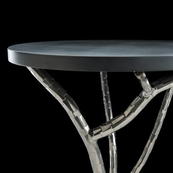 Every facet on every branch is individually hammered in our forge to create a unique sculptural base that supports a solid Vermont maple wood top. The Brindille Accent Table is available in all standard finishes. It is the perfect side or accent table for an organic, handcrafted, sculptural statement in any setting.