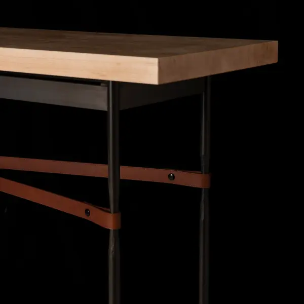 Society meets glam' in the Equus design. This Equus Console Table features sophisticated details including artisanally-made leather strapping connected by hand-forged and hammered ring elements, reminiscent of martingales. Four fullered legs support a solid Vermont Maple Top that completes the richness of materials complementing the steel and leather. Available in all standard finishes. - alternate view
