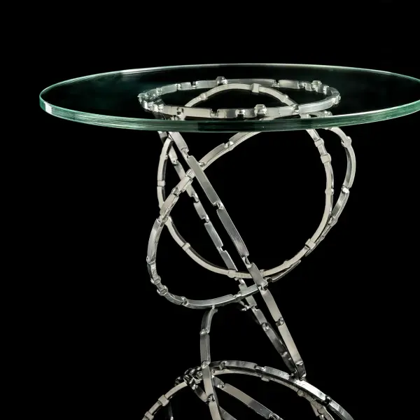 According to the Olympus' designer, David Martin, this is just the kind of puzzle he thrives on. "I was inspired by rings in creating the Olympus Collection." For this Olympus Accent Table, David's background as an Architect had him looking at cascading linear forms, creating movement using multiple rings in different orientations. Viewed through the glass top, the interaction of the hammered and stamped rings is mesmerizing. - alternate view