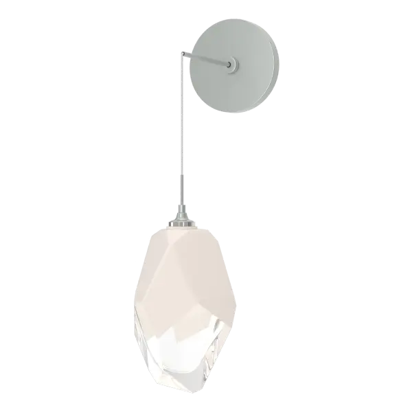 The Chrysalis Large Low Voltage Sconce features a large, handcrafted faceted glass crystal. You have the ability to set it at the drop height desired on its low voltage cable, creating unique opportunities for vanity, bedside and other applications. The Chrysalis’ trademark thick, clear layer of glass is encased in an outer layer of hand-blown, colored glass (matte black or white). Hand-polished like a gemstone, the lower portion of the outer layer of glass is removed to reveal the inner crystal clear layer below that is lit from within.