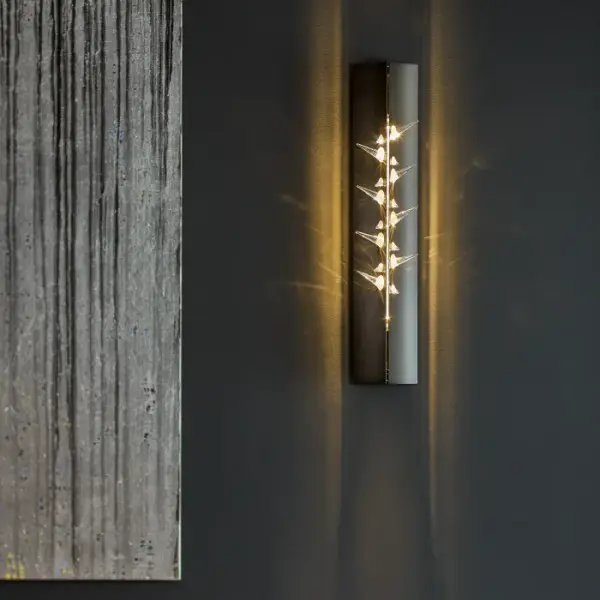 Seductively complex in nature, the Stitch weaves shimmering Swarovski crystals between two forged plates of steel. Laced together by the tenuous relationship between light and shadow, this alluring sconce creates a bold statement.