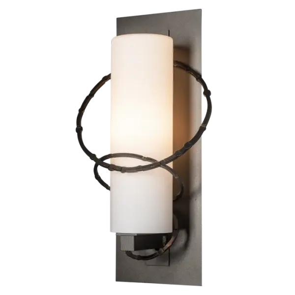 Trademark rings are hammered and stamped to create a unique texture. They intersect playfully with the mid-sized cylindrical shade in the Olympus Medium Outdoor Sconce. Available in a choice of robust Coastal Outdoor Finishes.