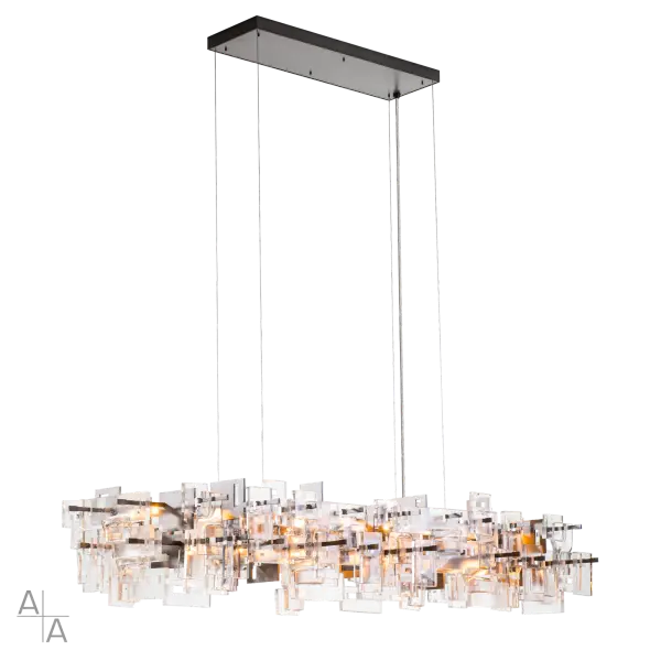 Part of ART + ALCHEMY by Hubbardton Forge, the Fusion Large Pendant is a modern pendant light that is perfect for a grand space. The staggered layers of thick, clear, seeded fused glass are displayed on a geometric metal framework. Incandescent bulbs give a warm wash of light over the entire composition.