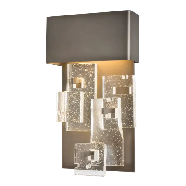 Add a touch of luxury to any room with the Fusion Small LED Sconce. It offers elegant and functional wall lighting at a versatile height of 16.4". Staggered layers of thick, clear, seeded, fused glass are displayed in a geometric pattern, on the fixture's aluminum backplate. - alternate view