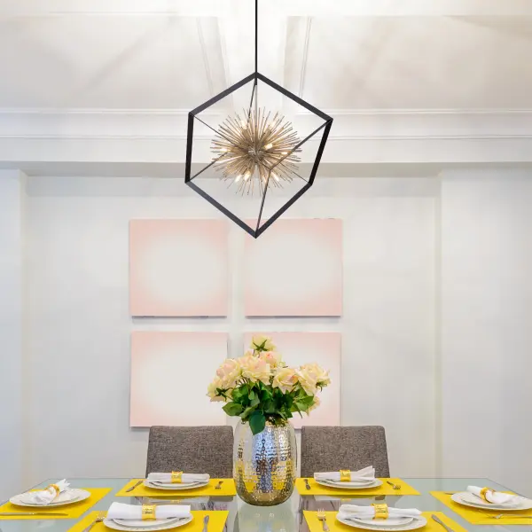 The Sunburst Collection chandelier is unique and a definitely beautiful focal point. The exterior frame is matte black encasing a satin brass cluster of thin hollow rods. (Smaller size and flush mount also available)