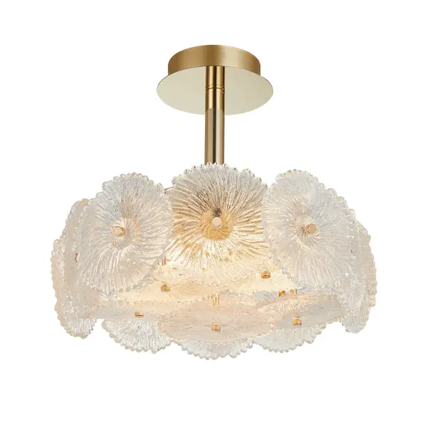 The defining feature of the Bloom collection lies in its enchanting glassware, meticulously crafted to resemble delicate and intricate flowers. The combination of the lustrous brass metal work and the floral-inspired glass elements makes this collection a captivating focal point for any space. The 6 lite semi flushmount is shown. (Matching chandeliers and wall sconce - alternate view
