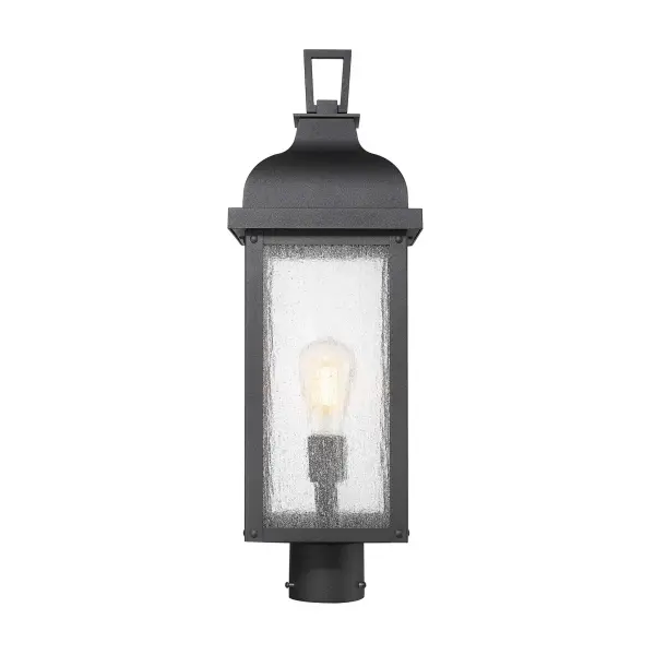 From the Madrid collection, this outdoor post exudes timeless charm with its rich black finish, evoking the romance of old-world craftsmanship. Its clear seeded glassware allows the light to shimmer beautifully, casting a warm, inviting glow. Traditional in design, its clean lines and graceful silhouette seamlessly enhance any outdoor setting.