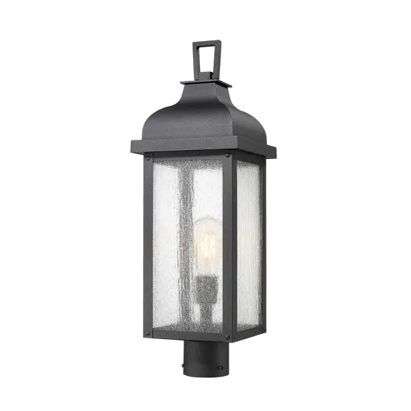 From the Madrid collection, this outdoor post exudes timeless charm with its rich black finish, evoking the romance of old-world craftsmanship. Its clear seeded glassware allows the light to shimmer beautifully, casting a warm, inviting glow. Traditional in design, its clean lines and graceful silhouette seamlessly enhance any outdoor setting. - alternate view