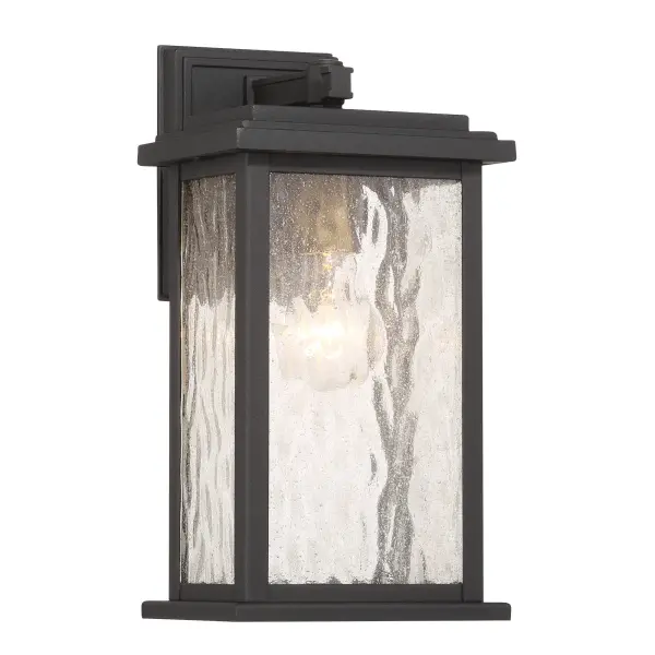 Brass with Rain Glassware The “Estate” Collection outdoor wall sconce radiates classic allure, with its black metal frame offering a striking contrast to the mesmerizing water glass panels. Encased within, vintage brass candle covers and intricate metalwork glow warmly, evoking a sense of nostalgic charm. Perfect for enhancing any outdoor space, this sconce blends classic sophistication with modern durability. - alternate view