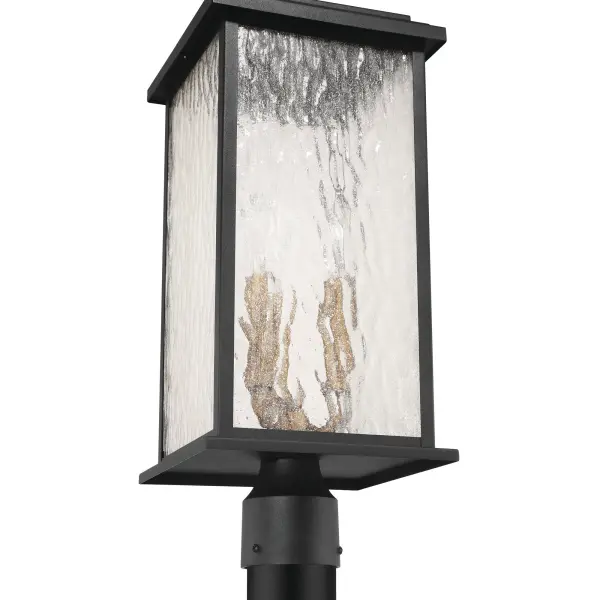 Brass with Rain Glassware The “Estate” Collection outdoor post radiates classic allure, with its black metal frame offering a striking contrast to the mesmerizing water glass panels. Encased within, vintage brass candle covers and intricate metalwork glow warmly, evoking a sense of nostalgic charm. Perfect for enhancing any outdoor space, this sconce blends classic sophistication with modern durability.