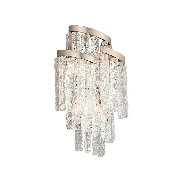 The Mont Blanc wall sconce combines hand-crafted clear Venetian glass with a modern silver leaf finish, creating a refined lighting solution that bridges traditional craftsmanship with contemporary aesthetics.