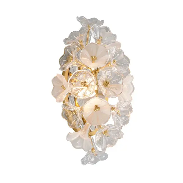 The Jasmine wall sconce combines handcrafted iron artistry with a luxurious gold leaf finish and clear glass shade. Its compact 9-inch width and 18-inch height make it ideal for flanking mirrors or creating ambient lighting in smaller spaces.