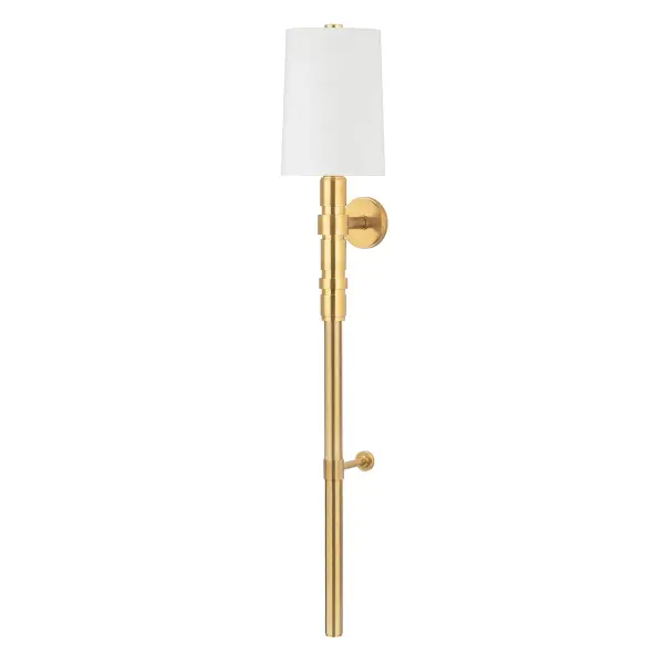 At nearly 5 feet tall, this dramatic wall sconce makes a bold architectural statement while serving as a space-saving alternative to traditional floor lamps. The vintage brass finish and industrial metalwork details balance beautifully with the soft white linen shade.