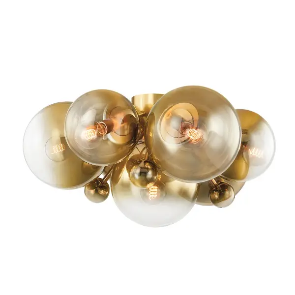 The Kyoto flush mount is a showstopper with its clusters of brass-to-clear ombre glass globes in varying sizes. The vintage polished brass finish adds warmth while the 30.5-inch span makes a bold statement in larger spaces.
