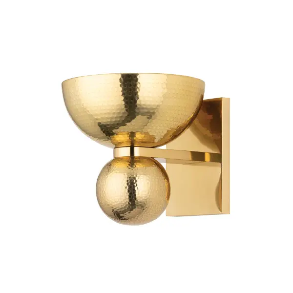 The Catania sconce brings antique jewelry aesthetics to wall lighting with its upward-facing bowl design and hammered brass finish. Compact yet impactful, it delivers vintage charm perfect for intimate spaces.