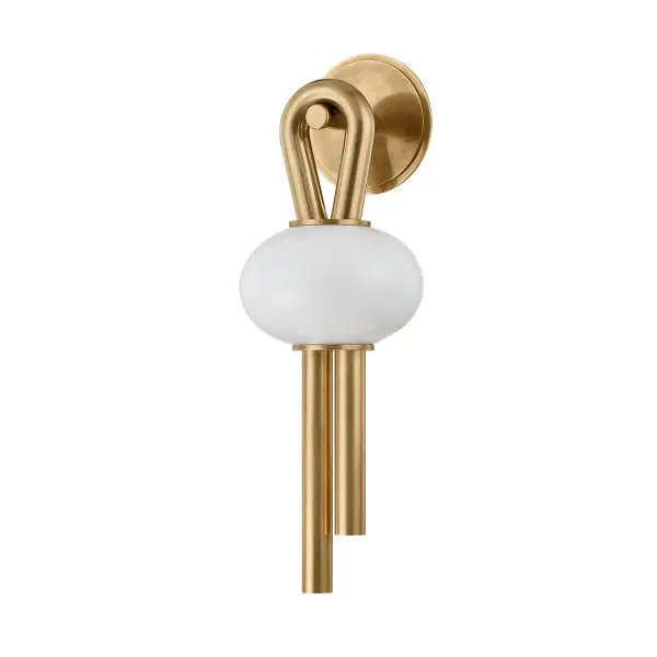 The Ala sconce brings artistic elegance to any space with its asymmetric loop design and suspended opal glass shade. The warm Vintage Brass finish complements the energy-efficient integrated LED, making it ideal for modern bathrooms and hallways.