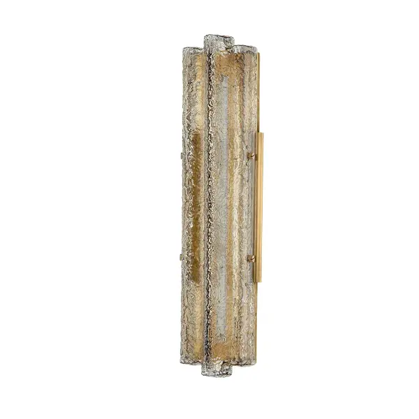 The Carnelian sconce captivates with its cluster of handblown champagne glass forms that create a mesmerizing interplay of light and shadow. The vintage brass metalwork provides a warm foundation for the icy glass elements, delivering both visual drama and functional illumination.