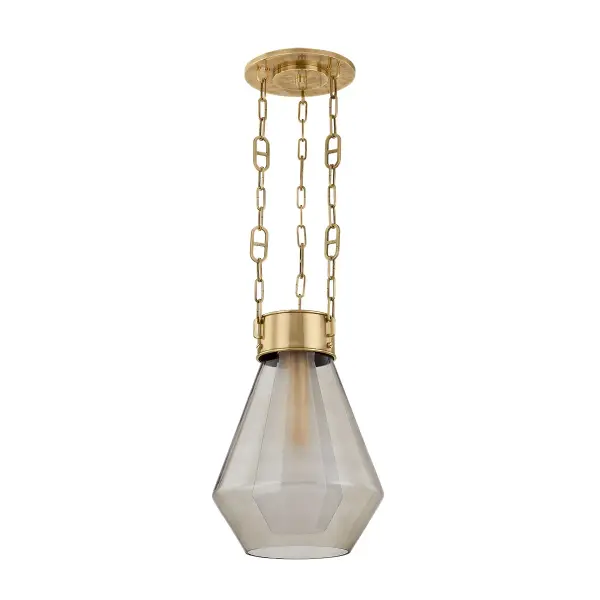 The Tragus pendant transforms jewelry design into lighting art with its faceted clear inner glass and curved light bronze outer shade. The vintage brass finish and custom mariner chain create an elegant focal point.