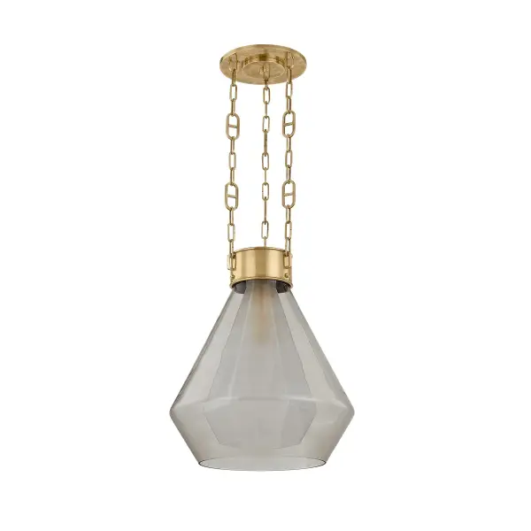The Tragus pendant transforms jewelry design into lighting art with its faceted clear inner glass and curved light bronze outer glass. The vintage brass finish and custom mariner chain create a gem-like suspended effect that's both sophisticated and approachable.