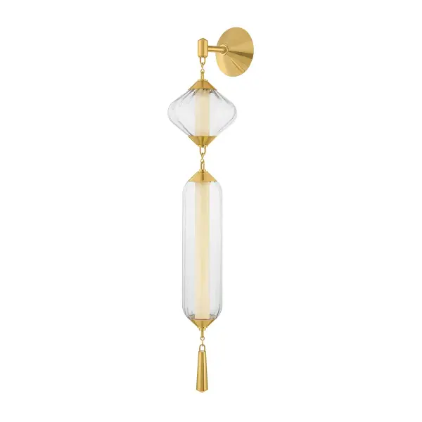 The Fiorello LED Wall Sconce combines geometric Art Deco shapes with contemporary LED technology. Its vintage polished brass finish and clear ribbed glass create a jewelry-like statement piece that works beautifully in both traditional and modern interiors.