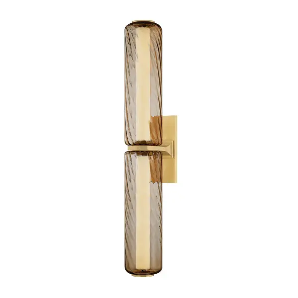 The Tuscany sconce makes a bold statement with its elongated 28.75-inch profile and hand-crafted topaz swirl glass. Integrated LED tubes create mesmerizing light diffusion through the twisted glass, while the vintage brass band provides elegant contrast.