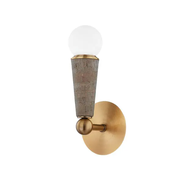 The Dax wall sconce combines organic materials with contemporary design, featuring a distinctive slate grey cork socket cup and patina brass details. Its compact 5-inch profile and opal globe create warm, diffused light ideal for intimate spaces.