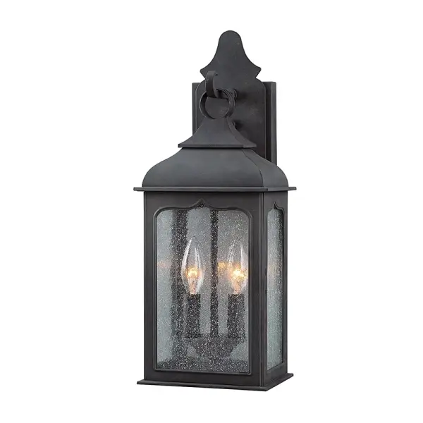 The Henry Street wall lantern combines traditional craftsmanship with durable outdoor construction. Hand-forged iron in textured bronze finish pairs with clear seeded glass for timeless curb appeal and reliable wet-rated performance.