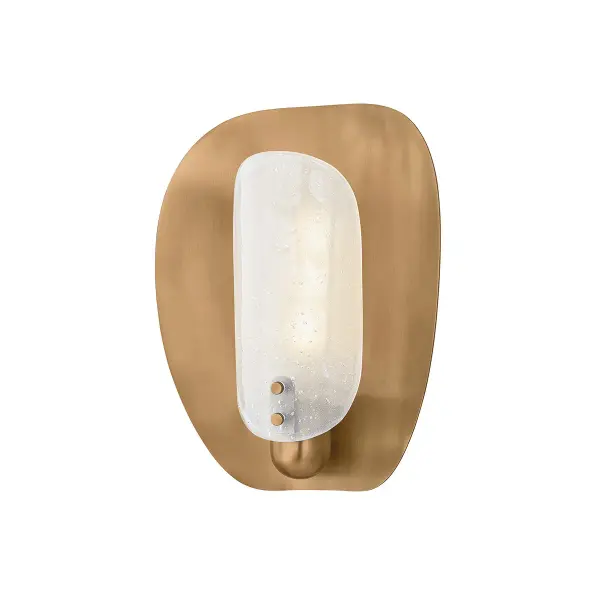 The Adler sconce brings organic coastal elegance with its coquina clam-inspired shell reflector in patina brass. The mesh-textured surface and bubble-like sprite glass create visual interest while providing soft, layered illumination.
