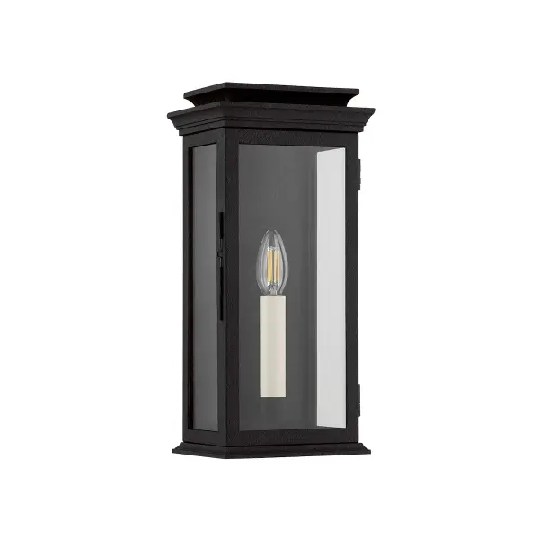 The Louie wall sconce brings vintage lantern character to outdoor spaces with its simple box shape, clear glass panels, and decorative chimney detail. The forged iron finish and wet-rated construction make it ideal for exposed exterior locations.
