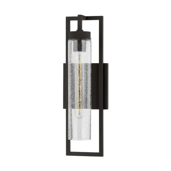 The Chester sconce delivers modern industrial style with its bold geometric lines and textured black aluminum frame. The clear seeded glass cylinder adds visual interest while the compact 6-inch width makes it ideal for tight spaces.