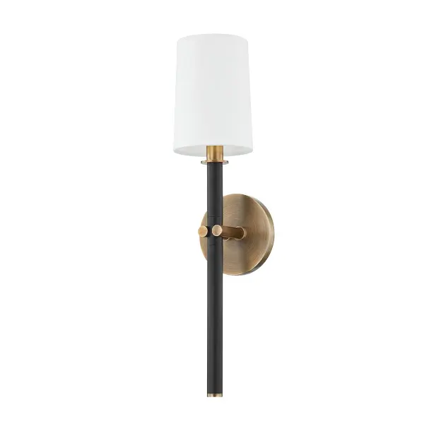 The Belvedere wall sconce blends traditional candlestick styling with modern detailing through its distinctive pinched-arm design. The two-tone Patina Brass and Texture Black finish creates visual sophistication in a compact profile.