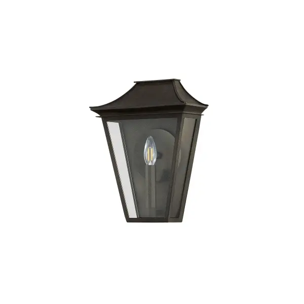 The Tehama wall sconce combines architectural design with functional illumination. Its reflector-backed candle design and clear glass panes maximize light output, while the angular frame and distinctive roof edges create visual interest.