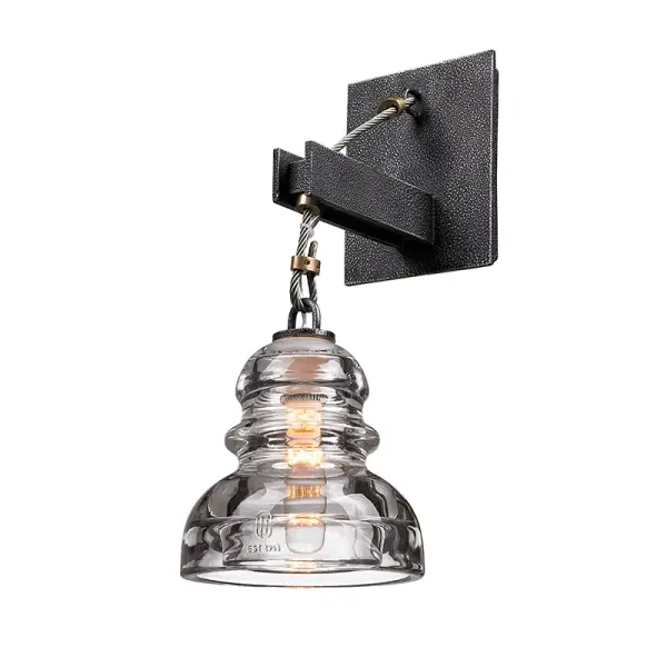 The Menlo Park sconce brings artisanal industrial style to bathroom and hallway lighting with hand-worked iron in an Old Silver finish and clear glass shade. Compact at under 6 inches wide, it's ideal for flanking mirrors or tight spaces.