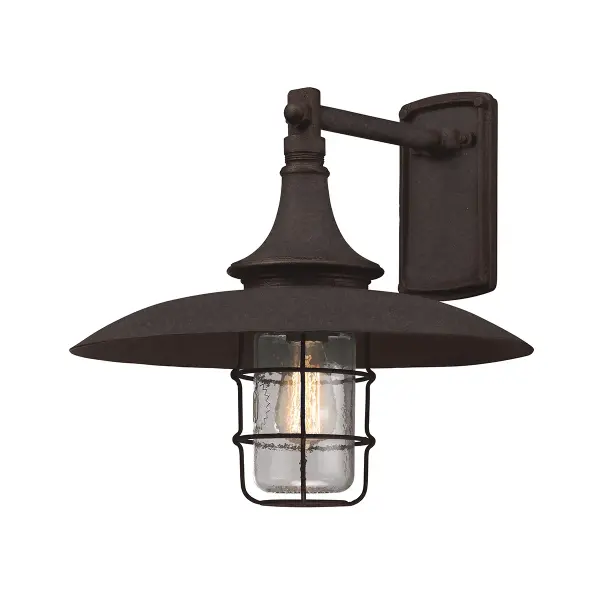 The Allegheny wall lantern combines traditional craftsmanship with modern durability. Hand-forged iron construction and heritage bronze finish create an authentic period look, while wet-rated certification ensures reliable outdoor performance.