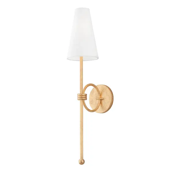 Magnus makes a bold statement at over two feet tall, combining vintage gold leaf metalwork with a refined white linen shade. Its architectural ring design and substantial presence elevate any space from bedroom to hallway.