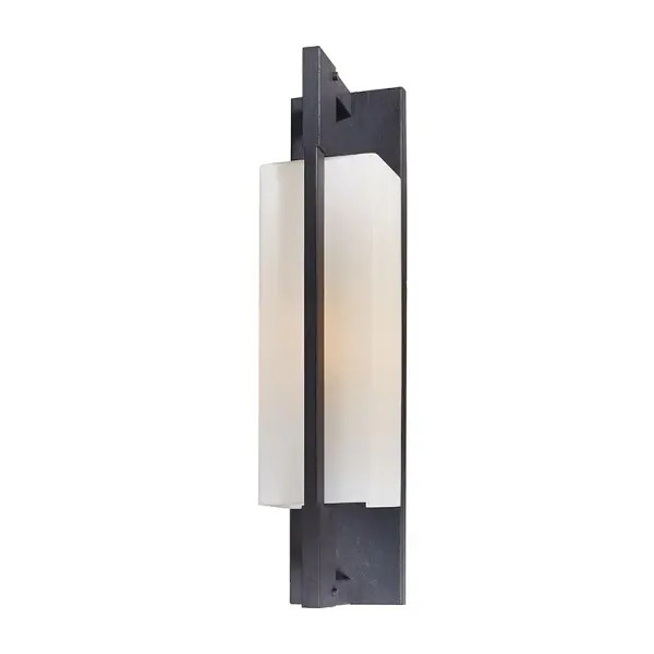The Blade wall bracket combines minimalist industrial design with hand-worked iron craftsmanship. Its wet-rated certification and compact profile make it ideal for both interior and exterior applications where clean lines matter.