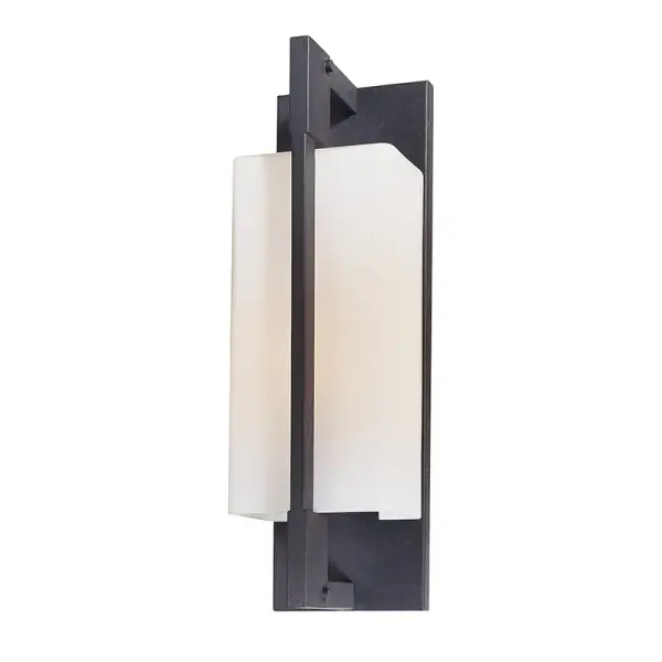 The Blade wall bracket combines minimalist industrial design with practical functionality. Its hand-worked forged iron finish and opal etched glass create a refined look suitable for both indoor and outdoor applications.