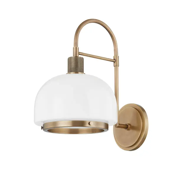 The Bradbury wall sconce combines sleek modern design with classic brass accents and knurled detailing. Its opal glass dome provides soft, diffused light while the curved arm adds architectural interest to any space.