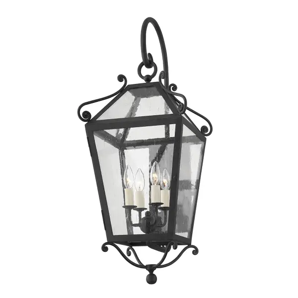 The Santa Barbara County sconce brings sophisticated Spanish colonial style to outdoor spaces with decorative scrollwork and dramatic 34-inch scale. Wet-rated for durability and designed by Mark D. Sikes.