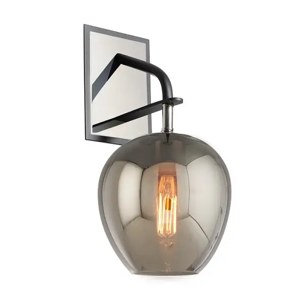 The Odyssey wall sconce combines hand-worked iron craftsmanship with smoke glass for a sophisticated, modern aesthetic. Its compact 7-inch profile makes it ideal for hallways and smaller spaces while delivering ambient lighting.