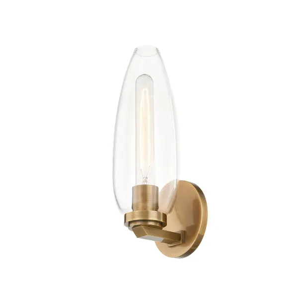 The Fresno wall sconce combines clean modern lines with a tulip-shaped clear glass shade that creates a lantern-like effect. Its compact 5-inch profile and warm patina brass finish make it adaptable to multiple design styles.