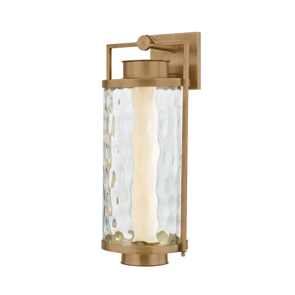 The Haddock LED Wall Sconce reimagines the traditional lantern with architectural elegance and premium materials. Its solid brass frame and hammered clear glass create sophisticated outdoor lighting that's both durable and beautiful.
