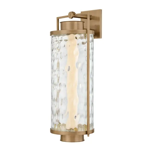 The Haddock LED Wall Sconce reimagines the traditional lantern with modern architectural lines and premium materials. Its solid brass frame and hammered clear glass create sophisticated outdoor lighting.