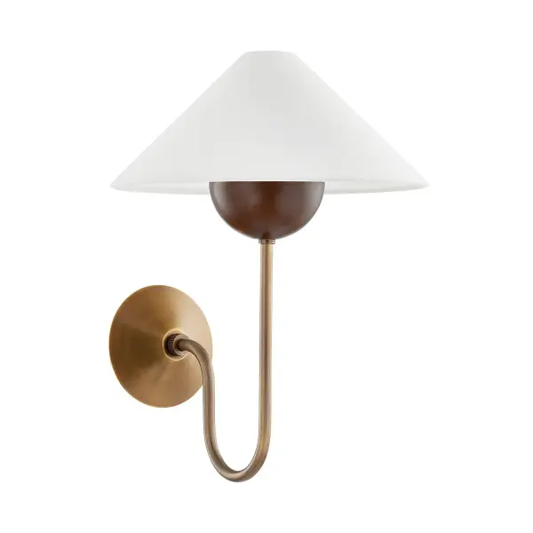 The Evan sconce stands out with its distinctive material mix and geometric composition. The swooping J-arm in warm patina brass, oversized walnut bobeche, and tapered linen shade create visual interest while maintaining organic sophistication.