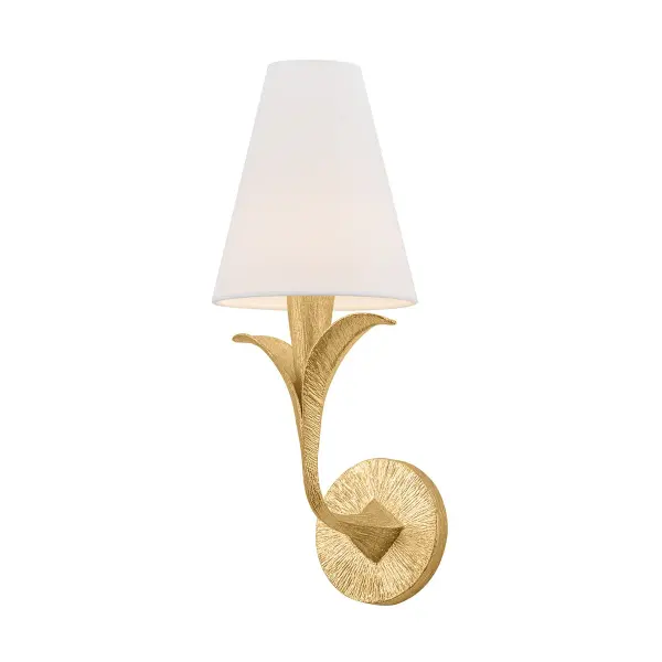 The Quill sconce brings organic elegance to any space with its curved armatures and leaf-like bobeche details. The Gilded Ivory finish adds a soft, sophisticated touch, while white linen shades provide warm, diffused light.