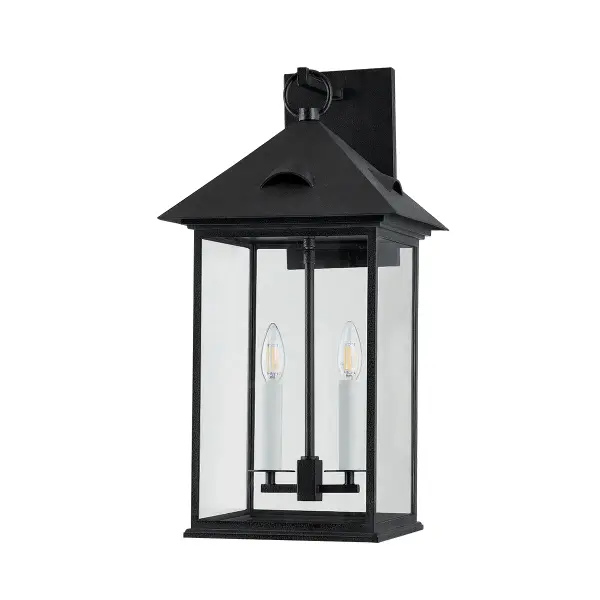 The Corning wall sconce blends heritage design with contemporary functionality. Its four clear glass panels and candle-style lighting create timeless appeal, while wet-rated aluminum construction ensures lasting outdoor performance.