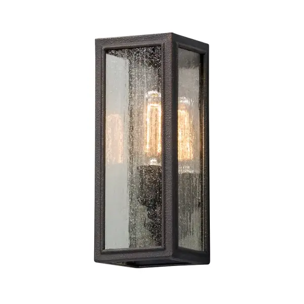 The Dixon wall lantern combines geometric metalwork with a soft silk shade for a balanced transitional aesthetic. Its compact 5-inch width and wet-rated construction make it ideal for smaller outdoor spaces.