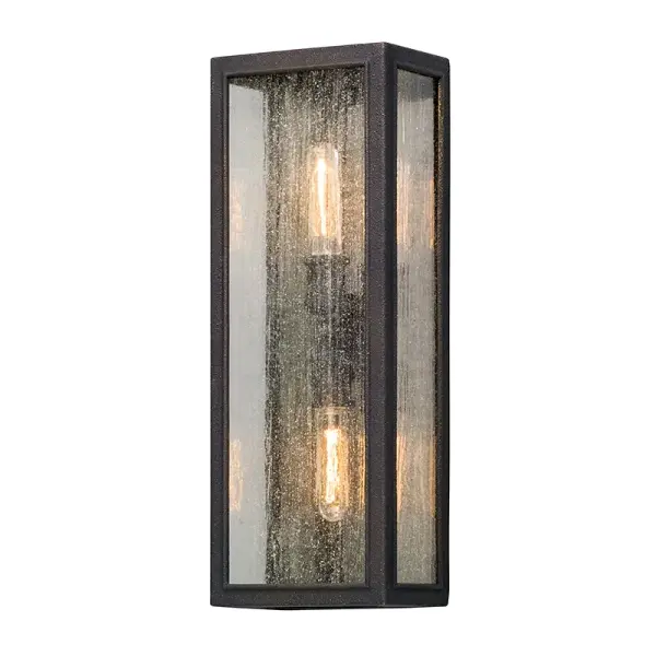 The Dixon wall lantern combines industrial metalwork with refined natural silk shading for a balanced transitional aesthetic. Its wet-rated construction and hand-crafted aluminum build make it ideal for exposed outdoor applications.